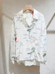 Chemise blanche fluide brodée motif marin en viscose, manches longues et coupe ample – disponible en tailles SM et ML.